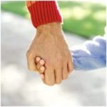 An old man holding a child's hand