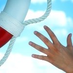 A hand reaching out for a life preserver.