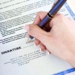 Person filling out power of attorney form