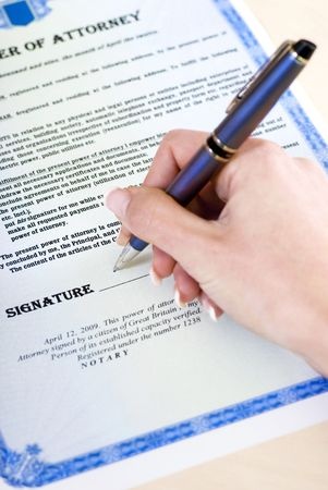 Person filling out power of attorney form