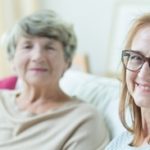 Elderly women sitting on sofa with daughter