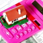 Estate planning documents with calculator and small toy home
