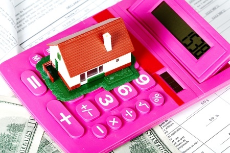 Estate planning documents with calculator and small toy home