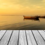 Pier overlooking boats with sunset in the background