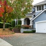 front view of modern residential home during early autumn season in northwest of united states. maple trees beginning to change leaf colors.