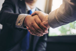 Business succession planning attorney shaking hands