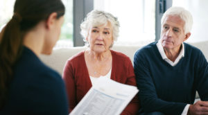Couple sitting with estate planning atorney