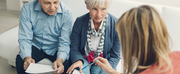 elderly couple consulting with an attorney