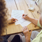Older woman discussing estate plan with attorney