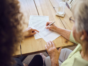 Older woman discussing estate plan with attorney