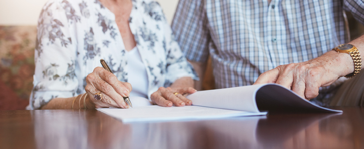 Elderly couple signing a testamentary trust
