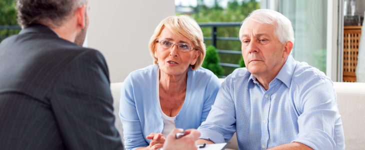 A attorney speaks with elderly couple